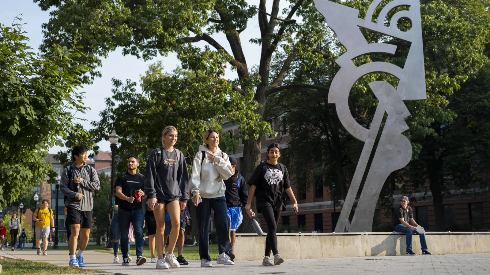 Students walking near a statue on the Columbus campus
