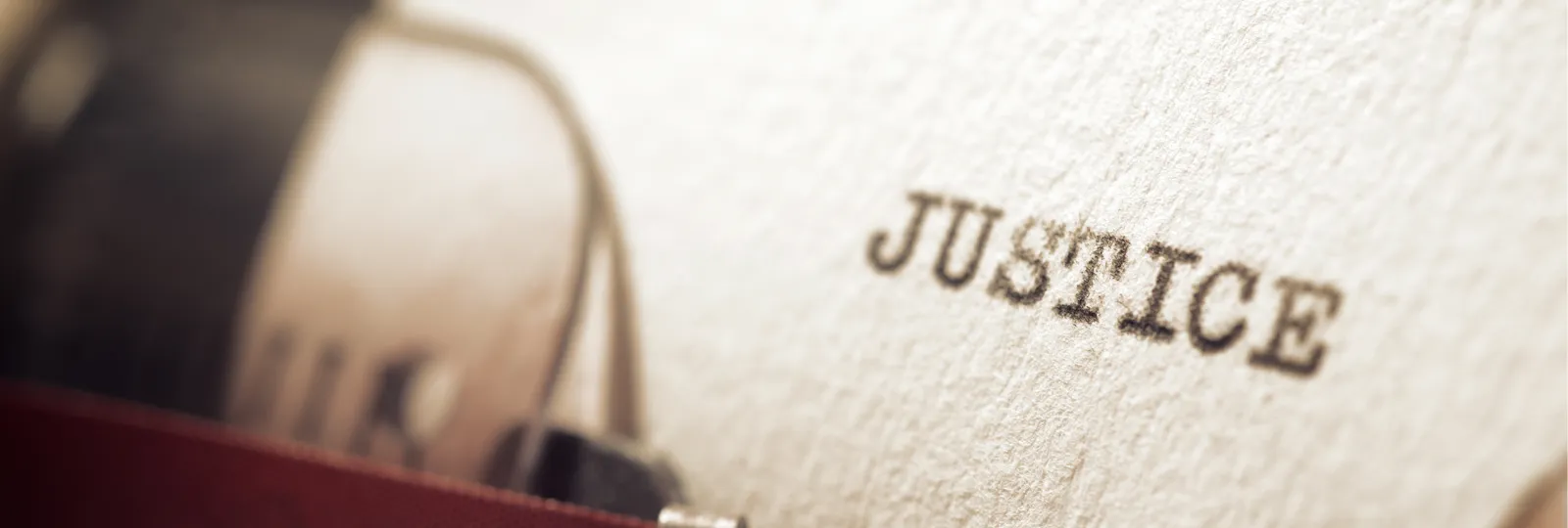 Paper with the word "justice" typed on it