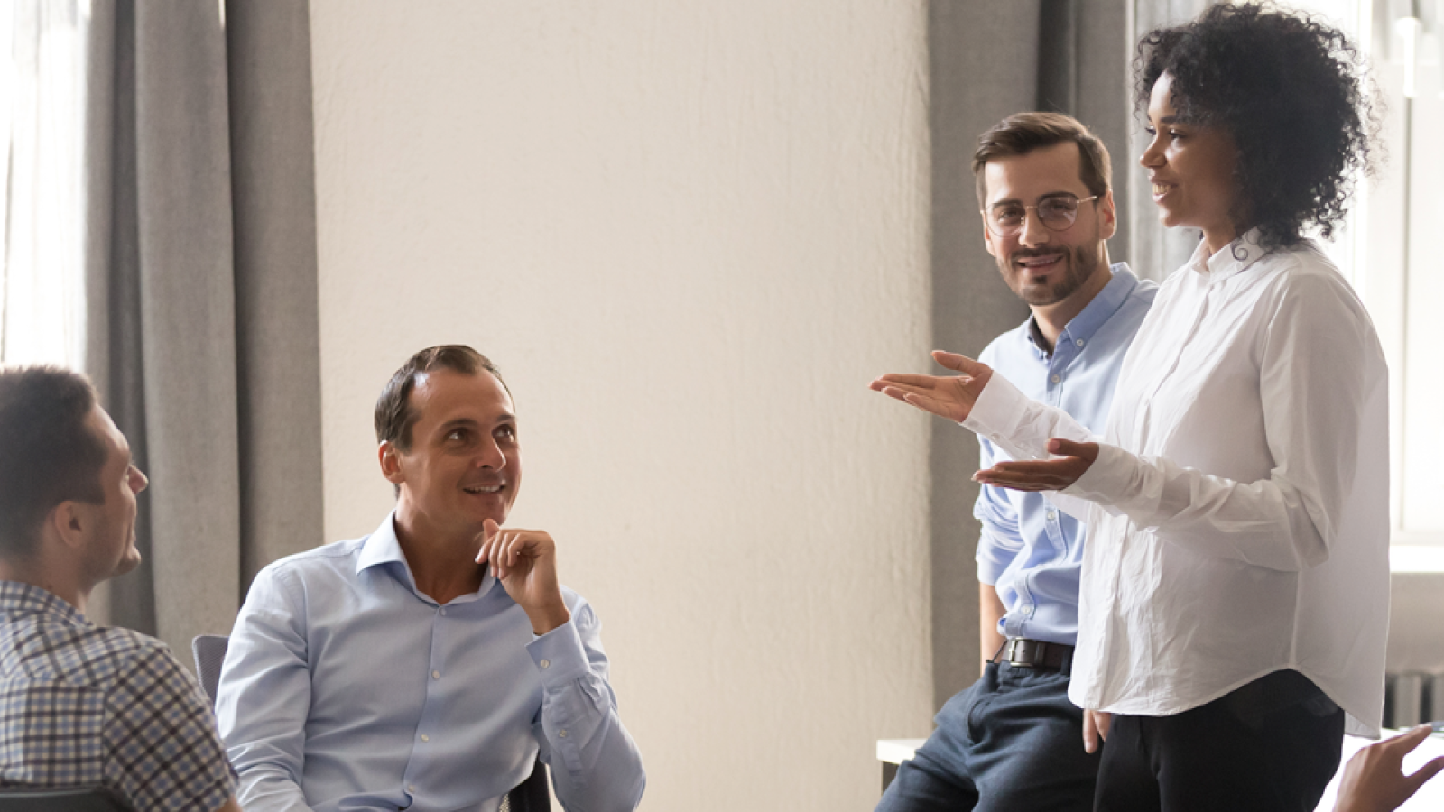 A group of people in an office having a meeting