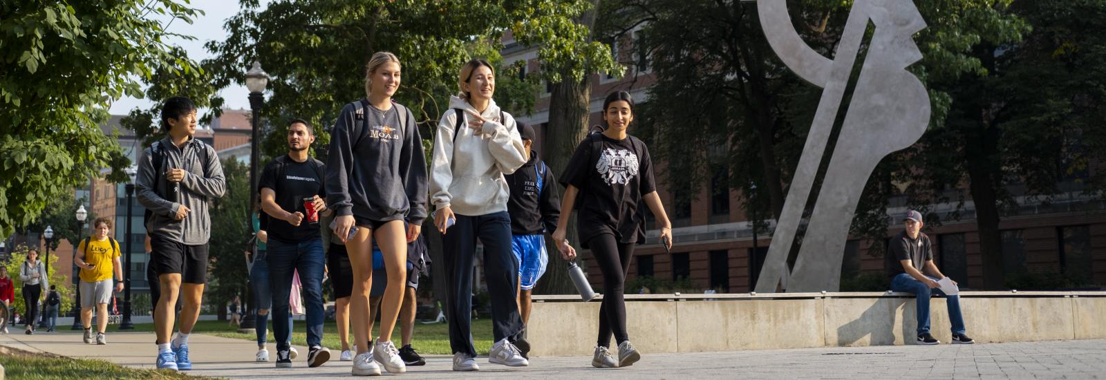 Students walking near a statue on the Columbus campus